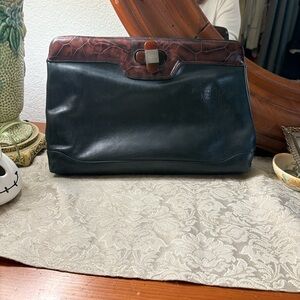 a Valentino Orlandi leather clutch with a crocodile-embossed top flap.